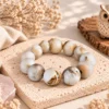 นกฮูก ริมโขง Online Store Image 19 ก.ย. 2569 11_37_25 สร้อยข้อมือ Wood Opal (ไม้กลายเป็นหินเนื้อโอปอล)